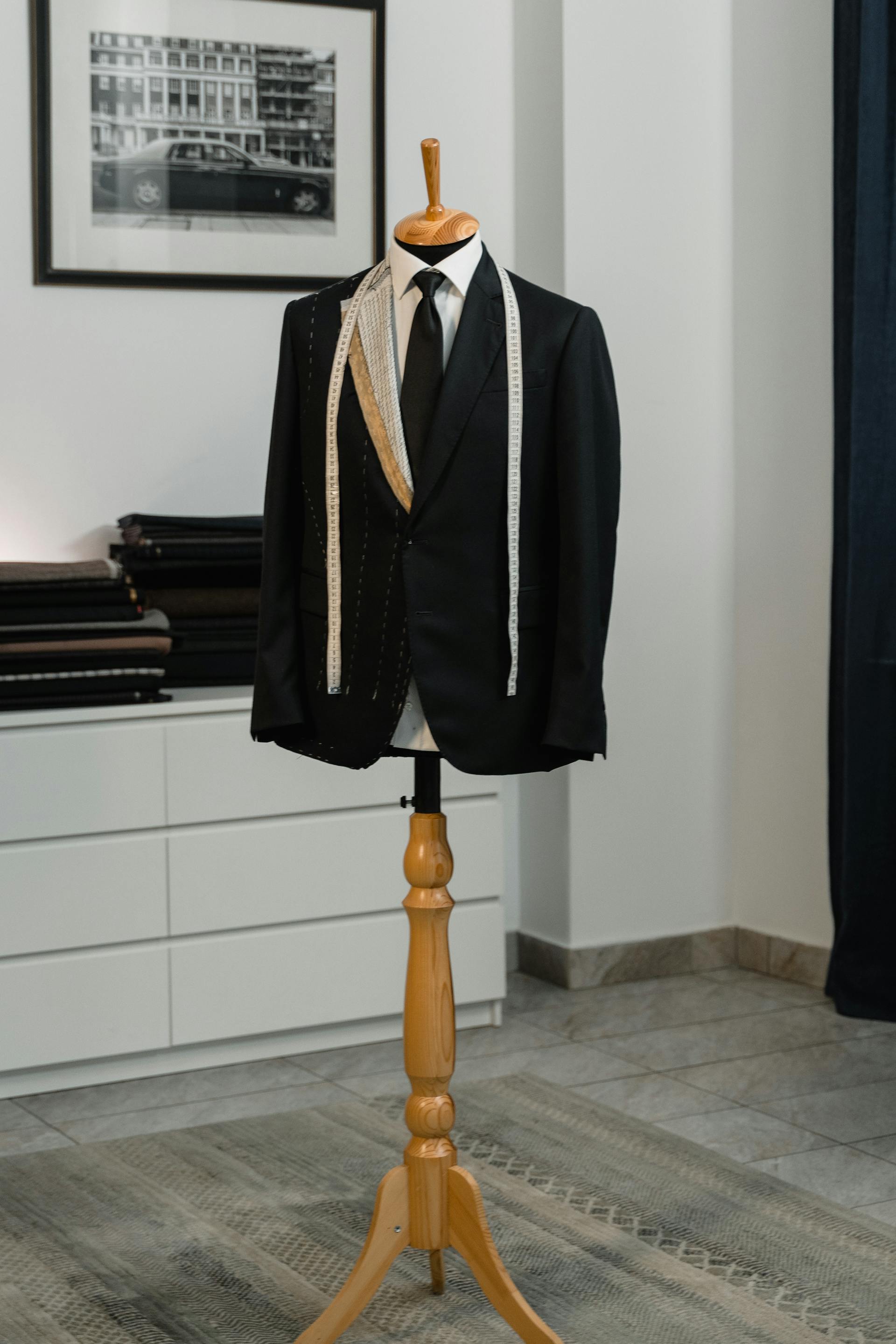 Bespoke suit on mannequin with measuring tape